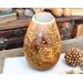 A gourd vase with sunflowers burned on the front and the inspirational phrase "bloom where you are planted".